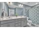 Stylish bathroom featuring a double vanity, modern fixtures, and a shower with a patterned curtain at 1022 Flagler St, Durham, NC 27713