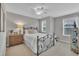 Comfortable bedroom with a ceiling fan, two windows and neutral decor at 1022 Flagler St, Durham, NC 27713