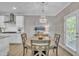 Open dining area features a stylish chandelier and a view of the modern kitchen at 1022 Flagler St, Durham, NC 27713