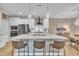 Spacious kitchen with an island with seating, stainless steel appliances, and open layout to the dining area at 1022 Flagler St, Durham, NC 27713