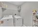 Functional laundry room with washer, dryer, and ample shelving for storage at 1022 Flagler St, Durham, NC 27713