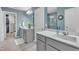 This is a shot of the main bathroom's dual sinks, neutral tiling, and walk-in closet at 1022 Flagler St, Durham, NC 27713