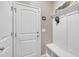 Clean mudroom featuring a built-in bench with hooks, and a white interior door at 1022 Flagler St, Durham, NC 27713