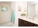 Well-lit bathroom with modern vanity, decorative accents and wall art at 103 Harrington Pt, Chapel Hill, NC 27516