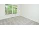 Empty bedroom with neutral carpet and view of greenery outside the window at 103 Harrington Pt, Chapel Hill, NC 27516
