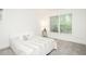 Bright bedroom with plush carpet, a comfortable bed, and a large window at 103 Harrington Pt, Chapel Hill, NC 27516