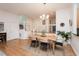 Bright dining area featuring hardwood floors, modern lighting, and stylish staircase at 103 Harrington Pt, Chapel Hill, NC 27516