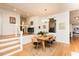 Elegant dining area with hardwood floors and modern light fixture, connecting seamlessly to other living spaces at 103 Harrington Pt, Chapel Hill, NC 27516