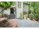 Inviting home entrance with stylish black door, well-maintained landscaping, and brick walkway at 103 Harrington Pt, Chapel Hill, NC 27516