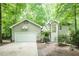 Charming home exterior with a basketball hoop above the garage, surrounded by mature trees at 103 Harrington Pt, Chapel Hill, NC 27516