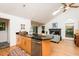 Bright kitchen features an island with black granite countertops that opens to the living area with a fireplace at 103 Harrington Pt, Chapel Hill, NC 27516