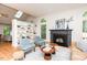 Cozy living room featuring a fireplace, hardwood floors, large windows, and elegant decor at 103 Harrington Pt, Chapel Hill, NC 27516