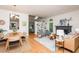 Open-concept living room with hardwood floors, a fireplace, and large windows for natural light at 103 Harrington Pt, Chapel Hill, NC 27516