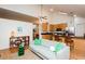 Bright living room area features hardwood floors, a ceiling fan, and open access to the kitchen and dining area at 103 Harrington Pt, Chapel Hill, NC 27516
