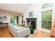 The living room has hardwood floors, a decorative fireplace, vaulted ceilings, and a large window with natural light at 103 Harrington Pt, Chapel Hill, NC 27516