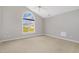 Neutral bedroom offering a bright window, neutral paint, and carpeted floors at 103 Rama Ct, Morrisville, NC 27560