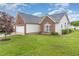 Spacious home featuring manicured lawn, a two-car garage, and a serene backyard at 103 Rama Ct, Morrisville, NC 27560