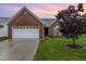 Charming brick home featuring a two-car garage, well-manicured lawn, and attractive landscaping at 103 Rama Ct, Morrisville, NC 27560