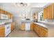 Open kitchen featuring wood cabinets, laminate counters, and modern white appliances at 103 Rama Ct, Morrisville, NC 27560