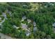 Aerial view featuring houses surrounded by trees, and a glimpse of a golf course in the distance at 107 Ivy Hollow Ct, Morrisville, NC 27560