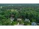An aerial view of suburban houses surrounded by trees, with a golf course in the background at 107 Ivy Hollow Ct, Morrisville, NC 27560