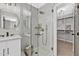Modern bathroom features a glass enclosed shower, marble tile, contemporary fixtures, and closet at 107 Ivy Hollow Ct, Morrisville, NC 27560
