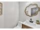Stylish half bathroom featuring modern fixtures and a decorative mirror at 107 Ivy Hollow Ct, Morrisville, NC 27560