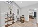 Cozy dining area with a rustic barrel table, a wooden chair, and a decorative shelving unit at 107 Ivy Hollow Ct, Morrisville, NC 27560