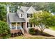 Charming two-story home with landscaped yard, a brick pathway, and a cozy front porch at 107 Ivy Hollow Ct, Morrisville, NC 27560