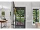 Inviting foyer with a screen door offering views of the landscaped front yard and a glimpse into the living space at 107 Ivy Hollow Ct, Morrisville, NC 27560