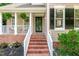 Inviting front entrance featuring brick steps, a charming porch, and beautifully landscaped surroundings at 107 Ivy Hollow Ct, Morrisville, NC 27560