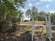 Pathway through the garden leading to green golf course beyond treeline at 107 Ivy Hollow Ct, Morrisville, NC 27560