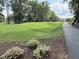 Expansive green golf course view with a walking path, mature trees, and manicured landscaping at 107 Ivy Hollow Ct, Morrisville, NC 27560