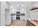 Modern kitchen with white cabinets, stainless steel appliances, and a stylish backsplash at 107 Ivy Hollow Ct, Morrisville, NC 27560