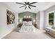 Serene main bedroom featuring a padded headboard, ambient lighting, soft carpet, and calm decor for relaxation at 107 Ivy Hollow Ct, Morrisville, NC 27560