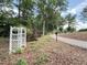 Picturesque view of a garden trellis near a path in a wooded, serene community at 107 Ivy Hollow Ct, Morrisville, NC 27560