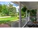 Cozy porch with comfortable seating and hanging ferns, offering a relaxing outdoor space with verdant views at 107 Ivy Hollow Ct, Morrisville, NC 27560