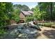 Expansive backyard with patio, wooden deck, mature trees creating an ideal setting for outdoor relaxation at 107 Silo Dr, Chapel Hill, NC 27514
