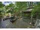 Gorgeous backyard garden featuring pagoda, wooden benches, and meandering walkway with beautiful landscaping at 107 Silo Dr, Chapel Hill, NC 27514