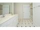 Bright bathroom features a white vanity, black and white tiled floors and a separate toilet and shower area at 107 Silo Dr, Chapel Hill, NC 27514