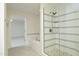 Bathroom shower with stone floors, a door to the main bedroom and white and grey horizontal tiles at 107 Silo Dr, Chapel Hill, NC 27514