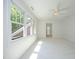 Sunlit bedroom with plush carpeting, large windows offering serene views, and a ceiling fan at 107 Silo Dr, Chapel Hill, NC 27514