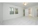 Carpeted bedroom with large windows, a door to a possible bath, and ample natural light at 107 Silo Dr, Chapel Hill, NC 27514