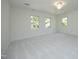 Bright and spacious carpeted bedroom with natural light streaming through multiple windows, offering a calming retreat at 107 Silo Dr, Chapel Hill, NC 27514