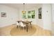 Charming dining area featuring light fixtures, windows, and a decorative round rug at 107 Silo Dr, Chapel Hill, NC 27514