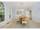 Bright dining room featuring a chandelier, hardwood floors, and large windows at 107 Silo Dr, Chapel Hill, NC 27514