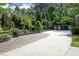 Long driveway leading to the main house, complimented by landscaped retaining walls and mature foliage at 107 Silo Dr, Chapel Hill, NC 27514