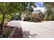 Charming brick home with lush landscaping, long driveway, and mature trees offering plenty of privacy at 107 Silo Dr, Chapel Hill, NC 27514