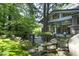 Exterior stone and glass wall with mature trees and unique stone landscaping features at 107 Silo Dr, Chapel Hill, NC 27514
