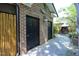 Unique entrance with a pair of exterior doors surrounded by bamboo and lush green landscaping at 107 Silo Dr, Chapel Hill, NC 27514